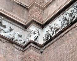 Roman/Greek relief sculpture attached to brick wall