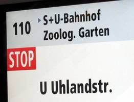 Screen in bus displaying next stop.
