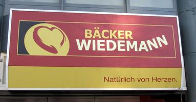 Wiedemann bakery; with “NN” going upwards at an angle as if there's not enough room on the sign