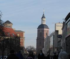 View down old Spandau street; church in background, stores at sides