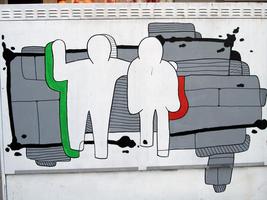 Power box painted with outline of two people walking down the street conversing