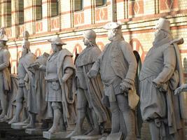 Close up of statues facing towards left of screen