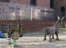 Child's playground area: Wooden cart on springs and wooden donkey