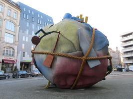 Another area of sculpture by Claes Oldenburg; large ball of burlap with household objects wrapped in rope