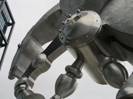 Detail of metal sculpture of horse, showing profile view of head and forelegs