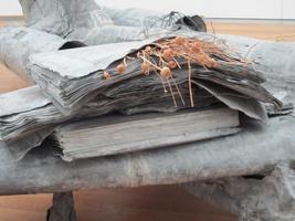 Detail of airplane, showing “engine” to be made of newspaper-sized sheets of paper