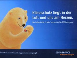 Poster showing polar bear tenderly holding a ladybug. Text: “Climate protection lies in the air and in our hearts.”