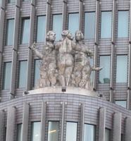 18th century statue on roof of 20th century building