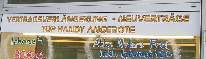 Sign on mobile phone store using curvy font