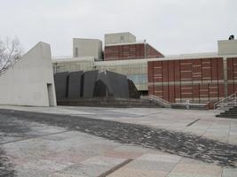 Brown brick building; black stone sculpture