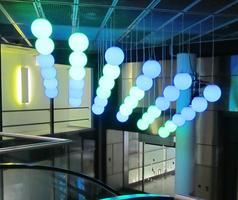 Spherical lamps hanging from ceiling; green and blue