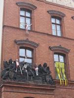rag doll mannequins hanging outside a building