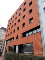 Façade of brick building in pattern of stripes and concentric squares