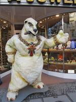 Sculpture of white bear smoking cigar and wearing “bling”