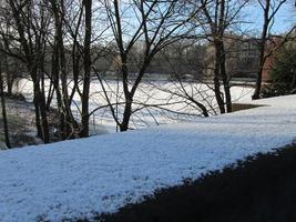 Snowed-over river in background; snow-covered railing in foreground