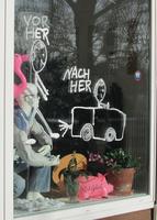 Sign in driving school window; walking stick figure labeled “before”; driving stick figure labeled “after.”