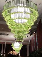 “Chandelier” made of flowers hanging upside down around a globe lamp