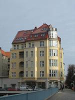 Old style yellow building with rounded corner