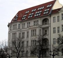 Gray old-style building with red roof