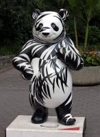Panda painted with shadows of branches and leaves; in front of National Zoo