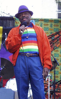 Willie Brown in blue hat and rainbow shirt