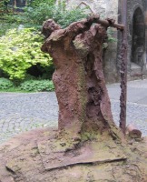 statue of person pulling on bar