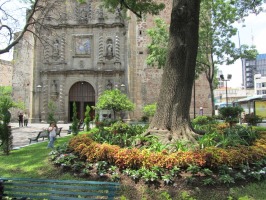 church door, with flowers and tree in foreground