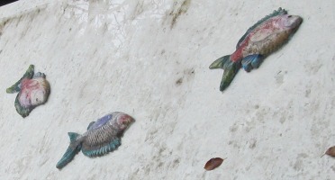 ceramic fish embedded in a fountain