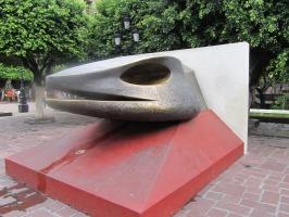 stylized metal serpent’s head on red base