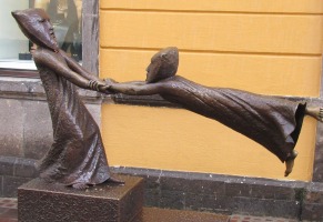 person holding a person flying horizontally because of wind