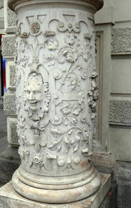 column with ornate reliefwork and smiling face