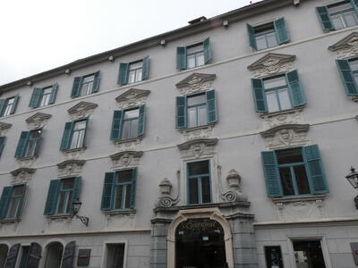old building with turquoise window shutters