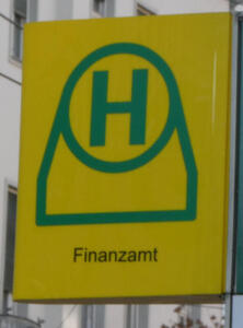 Tram/bus stop sign with H in green on yellow background.