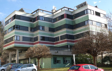 apartment building with green and red striped exterior