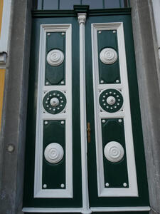 dark green door with white decoration elements