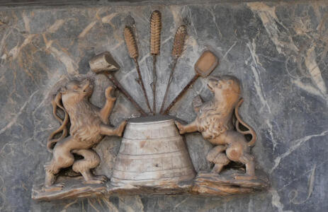 two lions beside baking tools and wheat stalks