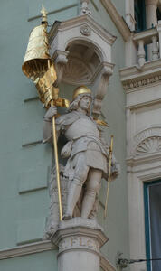 knight with gold helmet and staff with gold flag