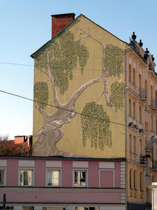 multi story building with painting of tree on wall