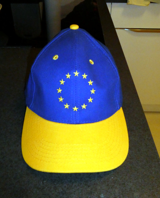 Blue baseball hat with yellow bill; on hat are the 12 yellow stars of the EU flag.