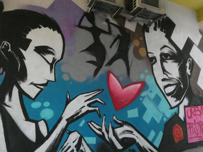 two young people with heart symbol between them