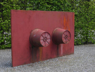 red metal plate with two cylindrical attachments