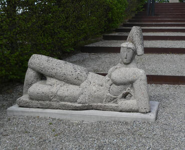 concrete sculpture reclining man