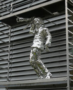 silver statue of person with camera