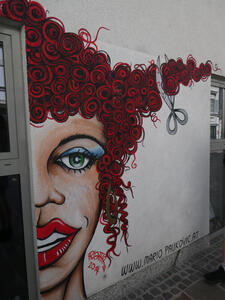 Wall painting of woman with curly red hair