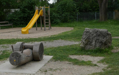 yellow plastic slide and bench in form of snail