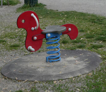 red hobby horse on blue spring