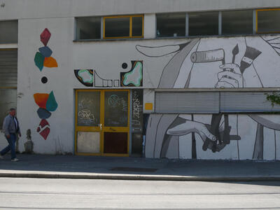 mural showing person holding paint brushes