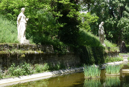 two statues near lake