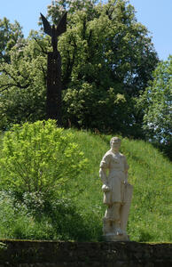At top left, a modern metal abstract. At bottom right, a white stone statue of a muscular man