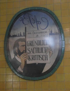 Poster of man with beard holding a „Der Tagesspiegel“ newspaper with headline Gründlich / Sachlich / Kritisch